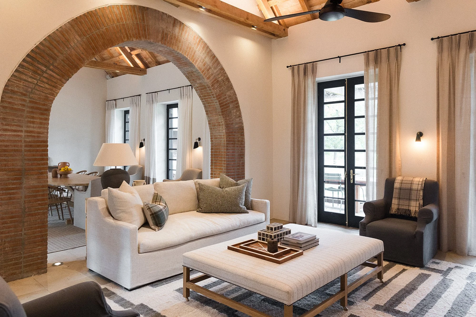 Living room with arched brick doorway
